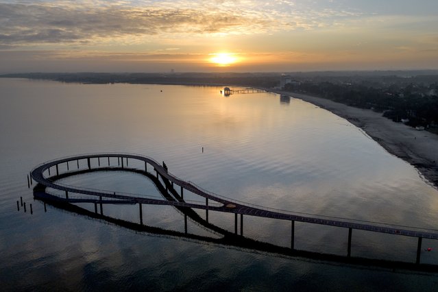 The new pier is pictured at the Baltic Sea in Timmendorfer Strand, Germany, as the sun rises on Thursday, January 9, 2025. (Photo by Michael Probst/AP Photo)