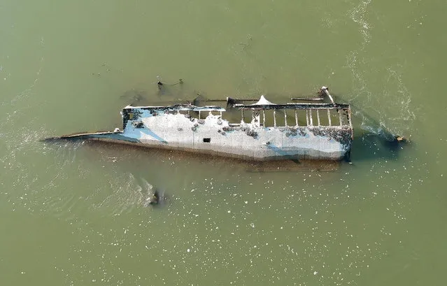 The wreck of a ship that sunk during World War II is revealed by the unusually low water level of the River Danube near Vamosszabadi, nortwestern Hungary, 17 August 2022. Researchers of Budapest's ELTE university warned that Hungary faces persistent droughts over the next few decades unless measures are taken to stop climate change. Dry areas are likely to expand in parts of the Great Plain, in eastern Hungary, as well as in the north-western parts of the country. Comparing recent data to figures from the 1970s-80s, the proportion of wetlands have shrunk from 84 percent to 68 percent, they added. (Photo by Csaba Krizsan/EPA/EFE)