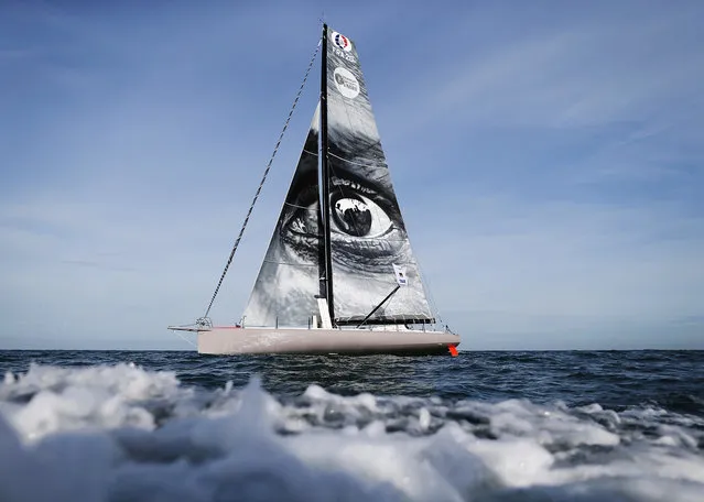 A picture taken during a training session off of the coast of Le Havre, northwestern France, on October 31, 2017 shows the “Vivo a Beira” monohull, Imoca bearing a work by French street artist JR on the sail, some days prior to the start of the 13th Transat Jacques Vabre sailing race, from Le Havre in France to Salvador de Bahia in Brazil. The race will start on November 5, 2017. (Photo by Charly Triballeau/AFP Photo)