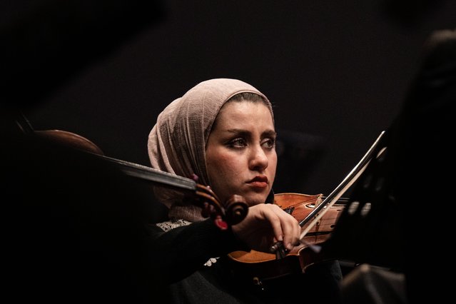 A violinist from the Iraqi National Symphony Orchestra plays during a concert at the Iraqi National Theatre in Baghdad, Iraq, Wednesday, November 27, 2024. (Photo by Hadi Mizban/AP Photo)