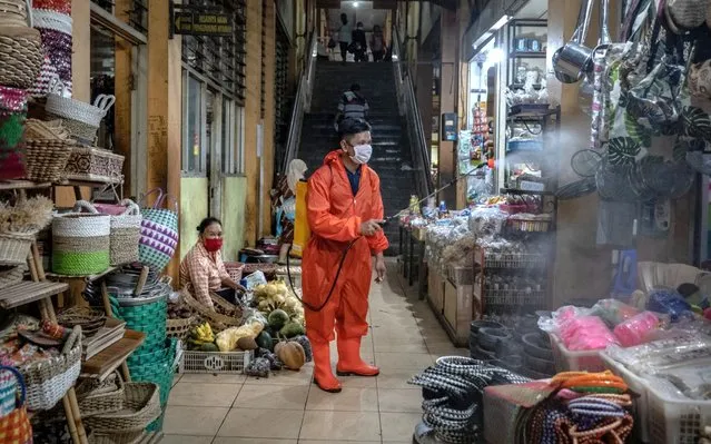 A janitor disinfects at a traditional market to curb the spread of COVID-19 amid the Coronavirus pandemic on June 4, 2020 in Yogyakarta, Indonesia. The Indonesian government will gradually open shopping malls, restaurants and entertainment sites from June in an attempt to open the economy even further despite a continuing rise in new Covid-19 coronavirus cases. Indonesia is struggling to contain hundreds of new daily cases of coronavirus, officials have so far confirmed over 29,000 cases of COVID-19 in the country with at least more 1,700 recorded fatalities. The coronavirus (COVID-19) pandemic has spread to at least 200 countries and territories around the world, claiming over 380,000 lives and infecting over 6 million. (Photo by Ulet Ifansasti/Getty Images)