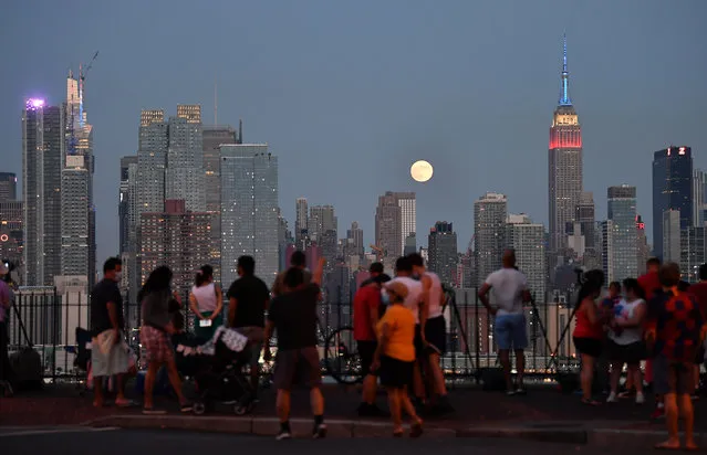 The moon rises before the Macy's July 4th fireworks from atop of the Empire State Building, from Hamilton Park in Weehawken, New Jersey on July 4, 2020. (Photo by Paul Martinka/The New York Post)