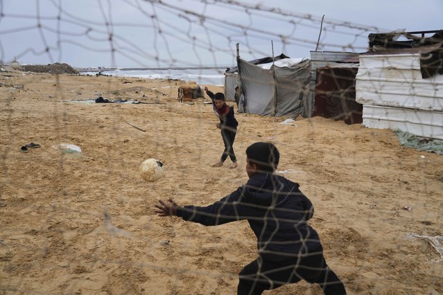 Displaced Palestinians kids play soccer at a makeshift tent camp in Deir al-Balah, Gaza Strip on Saturday, March 22, 2025. (Photo by Abdel Kareem Hana/AP Photo)