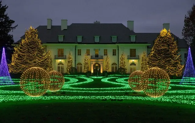 In this November 16, 2017 photo, The Lilly House at Newfields is part of the Winterlights holiday light display on the museum's grounds in Indianapolis. The display on the lawn of the home is synchronized to music from the Nutcracker. (Photo by Michael Conroy/AP Photo)