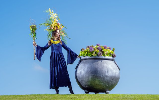 Ewa Mawdsley models an elaborate headdress woven from fresh spring blooms and wielding a floral staff, ahead of the Harrogate Spring Flower Show, UK on Wednesday, April 23, 2025. (Photo by Danny Lawson/PA Wire)