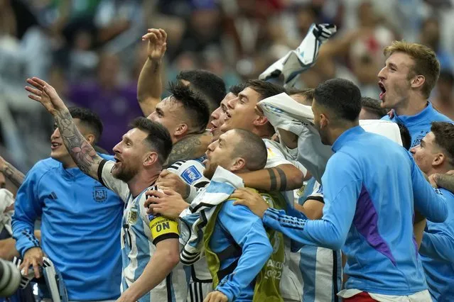 Argentina players celebrate after defeating the Netherlands off penalties during the World Cup quarterfinal soccer match between the Netherlands and Argentina, at the Lusail Stadium in Lusail, Qatar, Saturday, December 10, 2022. (Photo by Francisco Seco/AP Photo)
