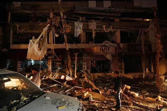 A picture shows a view of the wreckage left by a gas leak explosion at a student dormitory building in Dohuk in Iraq's autonomous Kurdistan region, early on November 22, 2022. - Five people died and 40 were injured in northern Iraq in a fire caused by a gas leak explosion at a student dormitory, authorities announced. The explosion occurred on November 21, 2022, at night when a rooftop gas tank leaked at a building housing a bakery and student accommodation in the Kurdish city of Dohuk. (Photo by Ismael Adnan/AFP Photo)