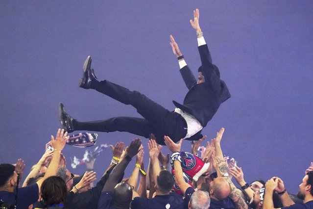 PSG staff throw club president Nasser Al-Khelaifi in the air during a celebration after the team won the Champions League final soccer match between Paris Saint-Germain and Inter Milan Sunday, June 1, 2025 at the Parc des Princes stadium in Paris. (Photo by Michel EulerAP Photo)