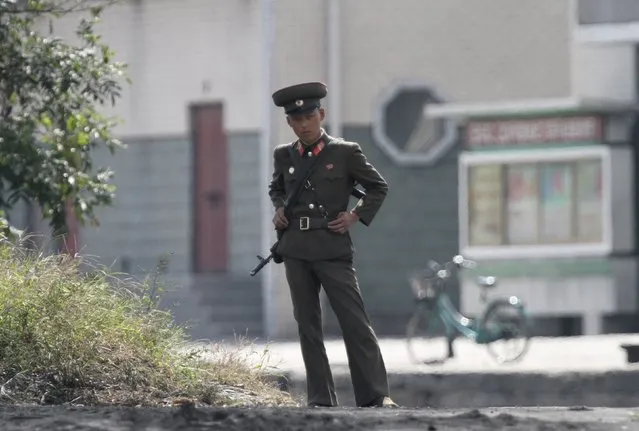 An armed North Korean soldier stands guard on the banks of Yalu River, near the North Korean town of Sinuiju, opposite the Chinese border city of Dandong, North Korea, September 9, 2015. (Photo by Jacky Chen/Reuters)