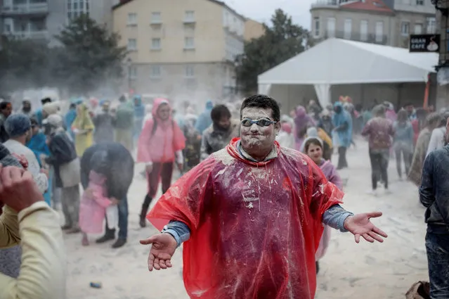 People attend the battle of flour, marking the beginning of the carnival celebrations in Xinzo de Limia, Galicia, northwestern Spain, 21 January 2018. As a purification ritual, the “Domingo Fareleiro” is a real battle of flour that takes place every year in the town, in a unique celebration that has the flour as its main protagonist, and gives the starting signal for a long festive period named “Entroido” (“Carnival” in Galician). (Photo by Brais Lorenzo/EPA/EFE)