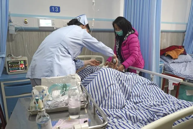 In this photo released by Xinhua News Agency, a wounded person receives medical treatment at a hospital following a traffic accident in Nanchang County in east China's Jiangxi Province, Sunday, January 8, 2023. A traffic accident in southern China killed more than a dozen people and injured more people early Sunday as the annual Lunar New Year holiday travel rush got underway, authorities said. (Photo by Wan Xiang/Xinhua via AP Photo)