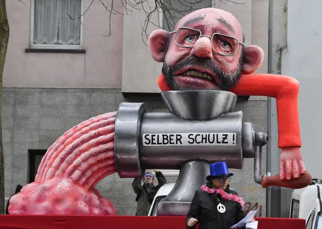 A float depicts Merkel's challenger in last year's election Martin Schulz put himself into a mincer during the traditional Rose Monday parade in Duesseldorf, Germany, Shrove Monday, February 12, 2018. (Photo by Martin Meissner/AP Photo)