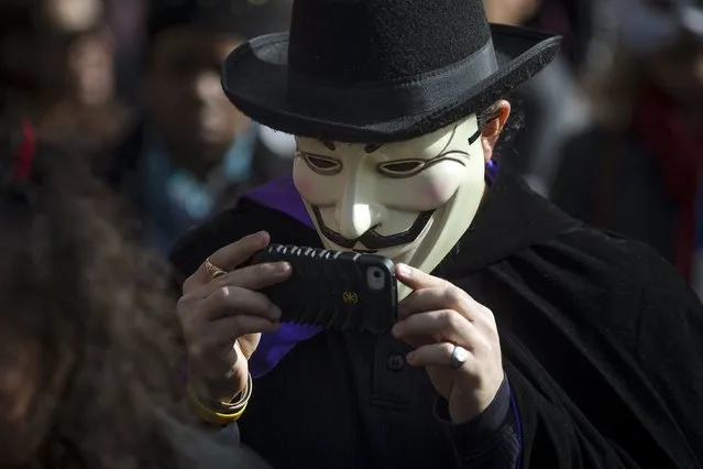 A person dressed in a Guy Fawkes mask takes part in the Children's Halloween day parade at Washington Square Park in the Manhattan borough of New York October 31, 2015. (Photo by Carlo Allegri/Reuters)