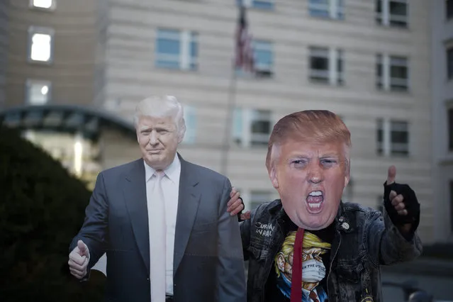 Gerd Lindner, as he said a huge fan of US President Donald Trump, poses near a paper mache effigy of Donald Trump with a Trump mask to support the President a day after the election, in the front of the United States embassy in Berlin, Germany, Wednesday, November 4, 2020. (Photo by Markus Schreiber/AP Photo)