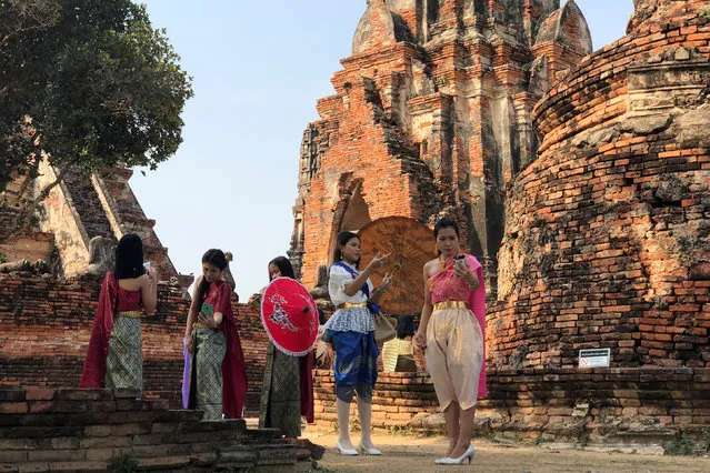 People dressed in traditional Thai costumes pose for a picture, as interest for historical clothing rises within the country, in Ayutthaya, Thailand April 6, 2018. (Photo by Juarawee Kittisilpa/Reuters)