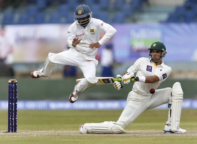Sri Lanka's Kaushal Silva (L) jumps away from the ball as Pakistan's captain Misbah-ul-Haq plays a shot during the first day of their first test cricket match in Galle August 6, 2014. (Photo by Dinuka Liyanawatte/Reuters)