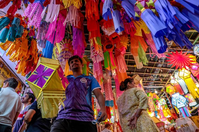 People browse colorful lanterns for sale at a local market ahead of the Diwali festival in Mumbai, India, 14 October 2025. The Hindu Festival of Lights, or Diwali, symbolizes the victory of good over evil, light over darkness, and marks Lord Rama's return to his kingdom, Ayodhya, after completing a 14-year exile. The main day of Diwali will be celebrated on 20 October this year. (Photo by Divyakant Solanki/EPA)