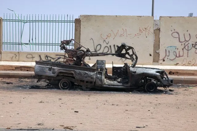 A destroyed military vehicle is seen in southern in Khartoum, Sudan, Thursday, April 20, 2023. The latest attempt at a cease-fire between the rival Sudanese forces faltered as gunfire rattled the capital of Khartoum. Through the night and into Thursday morning, gunfire could be heard almost constantly across Khartoum. (Photo by Marwan Ali/AP Photo)