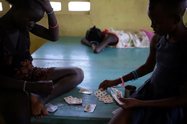 Two girls play cards at a temporary shelter after Hurricane Matthew hit Jeremie, Haiti, October 31, 2016. (Photo by Andres Martinez Casares/Reuters)