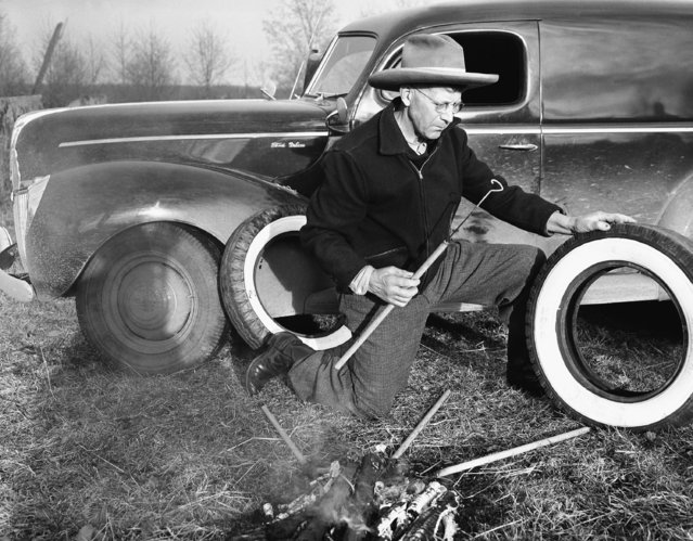 This Pacific Northwest “rancher” decided the best way to keep his tires identified, was to resort to old fashioned branding methods in Seattle, Washington on January 31, 1942. He whipped up some brick branding irons, built a regular branding fire, and proceeded to burn his own identification on his tires. (Photo by AP Photo)