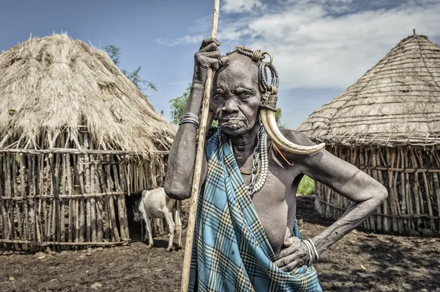 “Old Mursi woman”. Old woman by the huts of her village. Location: Marenke, Omo valley, Ethiopia. (Photo and caption by Jorge Fernandez/National Geographic Traveler Photo Contest)