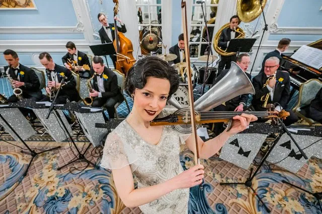 Rebecca Smith plays the Stroh violin in a replica vintage dress in London on March 31, 2022. The Savoy combines forces with Alex Mendham and his orchestra to raise funds for Ukraine. In the 1920s and 1930s the Savoy Orpheans were a household name, and for this charitable collaboration, the orchestra will become “The New Savoy Orpheans”, and create an exclusive recording in the hotel. They play in the hotel's Lancaster Ballroom, to record a medley of pieces that represent the finest melodies of the Jazz Age with the intention of raising valuable funds for the Disasters Emergency Committee. (Photo by Guy Bell/Alamy Live News)