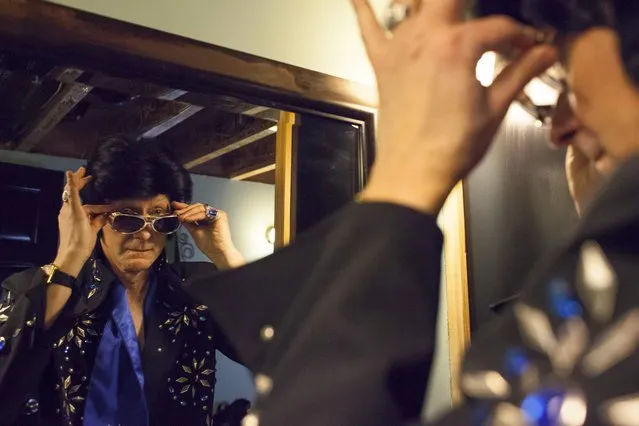 Clay Volz puts the final touches on his costume during the 20th annual Seattle Invitationals, an amateur Elvis impersonator competition, in Seattle, Washington January 23, 2015. (Photo by David Ryder/Reuters)