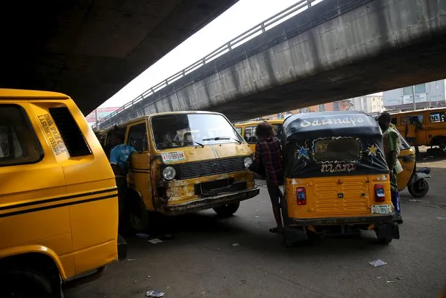 Commercial transports, packed with passengers, are seen under a bridge in Nigeria's commercial capital Lagos November 23, 2015. (Photo by Akintunde Akinleye/Reuters)