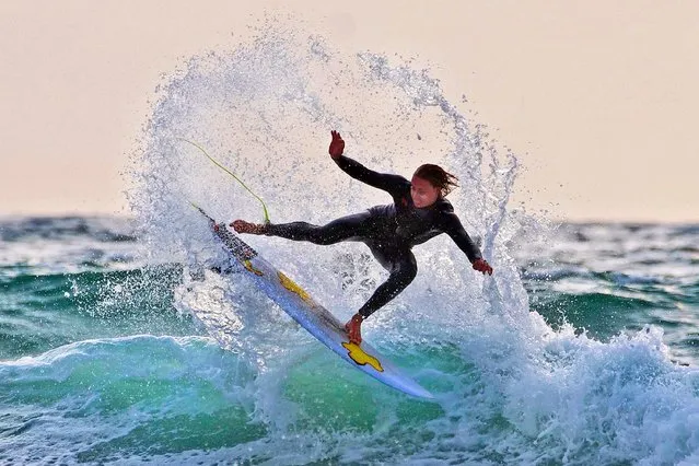 A surfer enjoys the warm weather in Polzeath, Cornwall, United Kingdom on June 26, 2023. (Photo by Su Wright/Story Picture Agency)