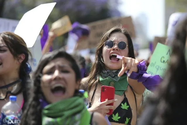 Women protest during a march to commemorate International Women's Day and protest against gender violence, in Mexico City, Monday, March 8, 2021. (Photo by Ginnette Riquelme/AP Photo)