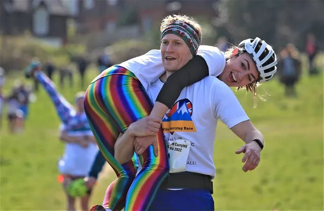 One couple finished with flying colours at the UK wife-carrying race in Dorking, Surrey on Sunday, April 10, 2022. The prize was a barrel of ale. (Photo by Peter Tarry/The Times)