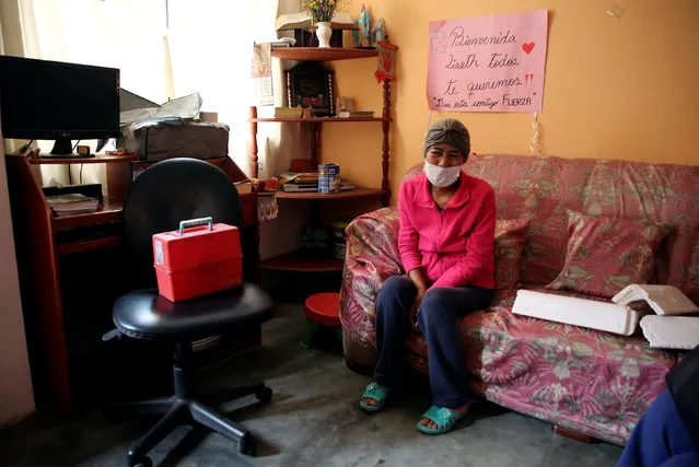 Liseth, 40, sits in her home next to a sign which reads 'Welcome Liseth, we all love you, God is with you, be strong'. She was diagnosed with tuberculosis six months ago whilst being treated for leukemia. Carabayllo in Lima, Peru September 22, 2016. (Photo by Mariana Bazo/Reuters)