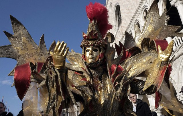 A masked reveller poses in St. Mark's Square during the Venice Carnival, February 7, 2015. (Photo by Stefano Rellandini/Reuters)