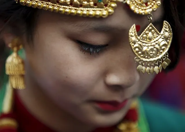 An adorned Gurung girl wearing traditional ornaments and costumes is pictured during the New Year parade in Kathmandu, Nepal December 30, 2015. (Photo by Navesh Chitrakar/Reuters)