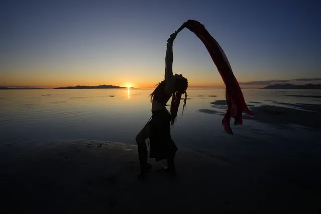 Kelsey Isis performs during a gathering of dancers and performers at sunset on the shoreline of the Great Salt Lake on June 15, 2023, in Magna, Utah. People are rejoicing after the winter's snow melted and increased the lake's elevation beyond last year's record low. (Photo by Rick Bowmer/AP Photo)