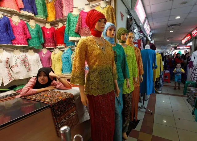 A shopkeeper waits for customers at a textile market in Jakarta, Indonesia February 27, 2017. (Photo by Fatima Elkarim/Reuters)