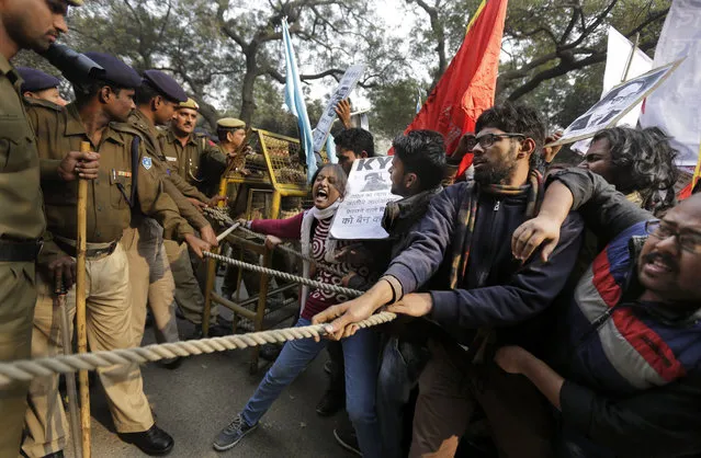 Indian students try to make their way through police barricade as they march towards the office of Hindu nationalist Rashtriya Swayamsevak Sangh (RSS) or the National Volunteers Association's office during a protest against the death of 26-year-old doctoral student Rohith Vemula in New Delhi, India, Saturday, January 30, 2016. Saturday marked the birthday of Vemula whose body was found hanging in a hostel room, on January 17 weeks after he along with four others, was barred from using some facilities at his university in the southern tech-hub of Hyderabad. (Photo by Altaf Qadri/AP Photo)