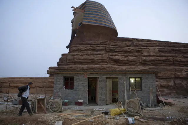 A man walks near a full-scale replica of the Sphinx at an unfinished movie and animation tourism theme park, in Chuzhou, Anhui province, March 28, 2015. (Photo by Reuters/China Daily)