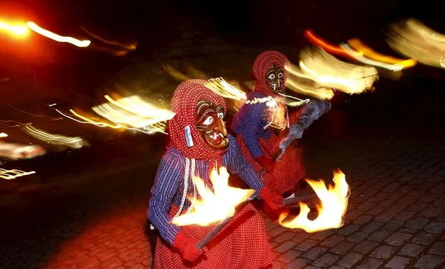 A group of traditional witches (Kandelhexen) dance around a bonfire during their traditional “witches sabbath” carnival performance in the Black Forest village of Waldkirch, Germany, February 6, 2016. (Photo by Kai Pfaffenbach/Reuters)