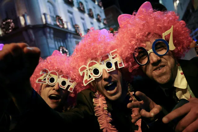 Revellers take part in New Year's celebrations at Puerta del Sol square in central Madrid, Spain December 31, 2016. (Photo by Susana Vera/Reuters)