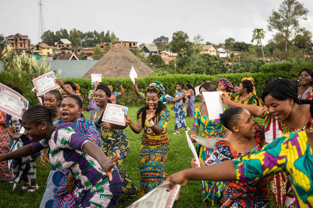 Students sing and dance after receiving their certificates during their graduation party from the City of Joy in Bukavu on December 19, 2018. The City of Joy in Bukavu welcomes 180 women every year from across the Democratic Republic of Congo who have suffered sexual abuse, and provides training in various small businesses such as sewing or soap making, as well as self defence. Divided into two groups, one from January to June, and the other from July to December, the women spend six months at the City of Joy, where they also receive individual and group counseling. (Photo by Fredrik Lerneryd/AFP Photo)