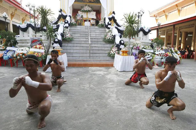 In this Thursday, November 15, 2018, photo, Thai boxers perform their traditional dance showing respect at the coffin of 13-year-old Thai kickboxer Anucha Tasako during his funeral services in Samut Prakan province, Thailand. Anucha died of a brain hemorrhage two days after he was knocked out in a bout on Nov. 10 that was his 174th match in the career he started at age 8. Thai lawmakers recently suggested barring children younger than 12 from competitive boxing, but boxing enthusiasts strongly oppose the change. (Photo by Sakchai Lalit/AP Photo)