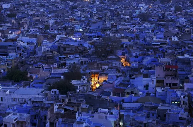 A general view of the residential area is pictured during dusk at Jodhpur in Rajasthan, April 5, 2015. Jodhpur, also known as the blue city in the desert Indian state of Rajasthan, which residents say originally, was used to show where the highest caste of priestly Hindus live, who wanted to set them apart from the rest of the population. Later the rest of the population followed suit. Another reason for the city to be blue is to keep the buildings cool during the summers, local residents said. (Photo by Adnan Abidi/Reuters)