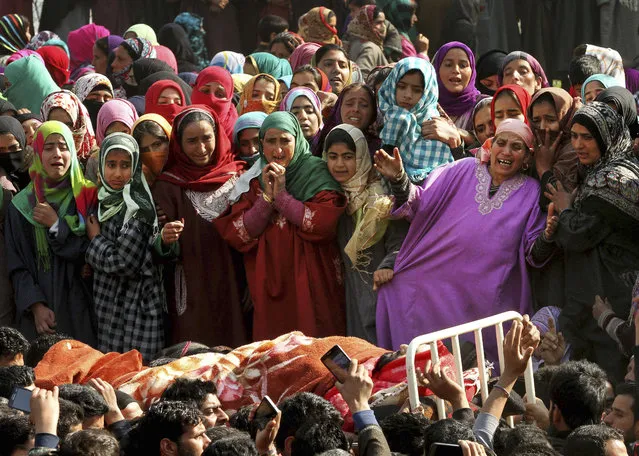 Kashmiri women villagers wail as they watch the body of Asif Ahmad, a suspected rebel, during his funeral procession in Dadsar village, 40 kilometers (25 miles) south of Srinagar, Indian controlled Kashmir, Thursday, March 3, 2016. Three Kashmiri rebels were killed in a gunbattle with government forces early Thursday as they tried to break through a security cordon in the disputed Himalayan region of Kashmir, the army said. (Photo by Mukhtar Khan/AP Photo)