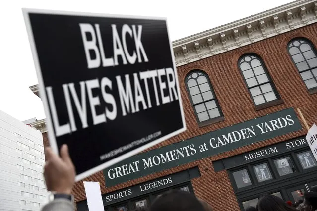 Demonstrators gather near Camden Yards to protest against the death in police custody of Freddie Gray in Baltimore April 25, 2015. At least 2,000 people protesting the unexplained death Gray, 25, while in police custody marched through downtown Baltimore on Saturday, pausing at one point to confront officers in front of Camden Yards, home of the Orioles baseball team. (Photo by Sait Serkan Gurbuz/Reuters)