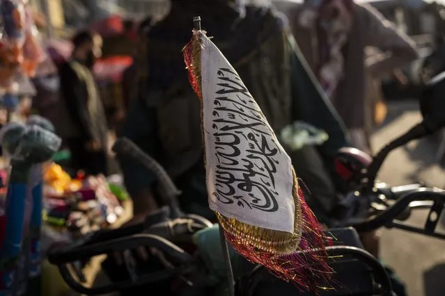 A Taliban flag is placed in the front of a motorbike in Kabul, Afghanistan, Tuesday, September 28, 2021. (Photo by Bernat Armangue/AP Photo)