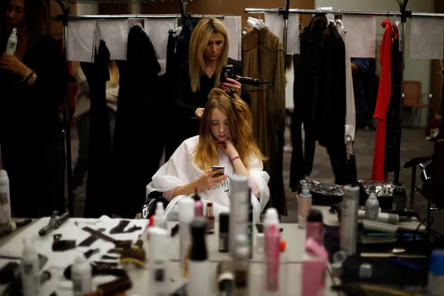 A fashion model gets ready backstage before the Fall/Winter 2019/2020 collection show by designer Fatima Lopes, in Lisbon, Portugal April 5, 2019. (Photo by Pedro Nunes/Reuters)