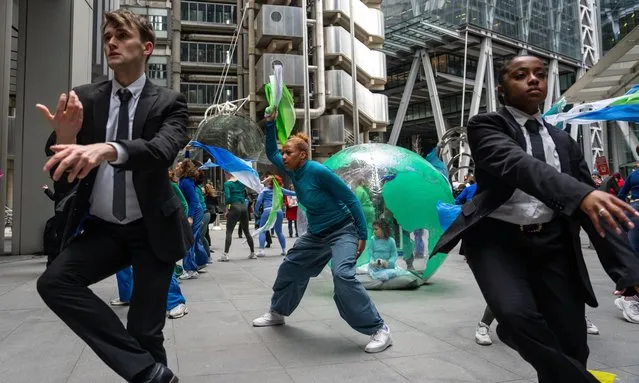 Dancers working with Mothers Rise Up (a group of UK mothers protesting about climate change) prepare to hold a performance protest outside Lloyds of London on February 26, 2024 in London, United Kingdom. Organised by Mothers Rise Up, a climate activism group advocating for every child's right to a safe climate and clean air, this performance was crafted with Denni Sayers, a mother, choreographer, and director in opera and theatre. (Photo by Carl Court/Getty Images)