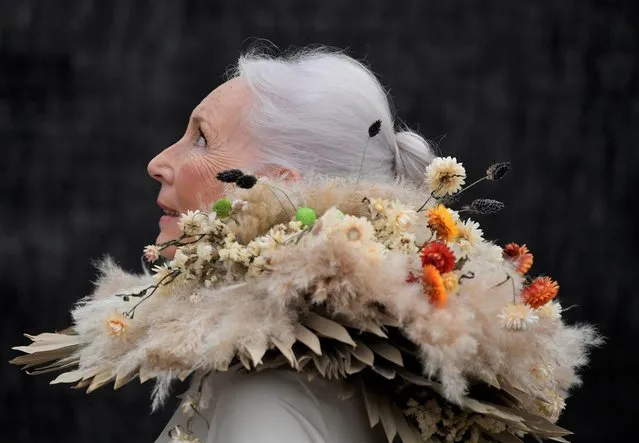 A woman wearing clothing made from dried flowers attends the RHS Chelsea Flower Show, delayed from its usual spring dates because of lockdown restrictions amid the spread of the coronavirus disease (COVID-19) pandemic, London, Britain, September 20, 2021. (Photo by Toby Melville/Reuters)