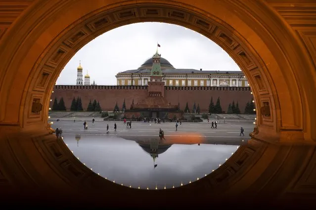 The Kremlin is reflected in a glass seen through an arch of the GUM, the State Shop in Red Square in Moscow, Russia, Wednesday, September 22, 2021. (Photo by Alexander Zemlianichenko/AP Photo)